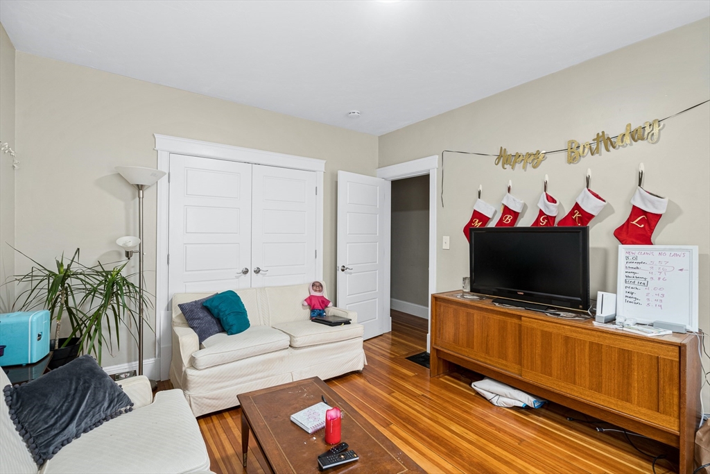 79 Saxton Street, Unit 3 Boston, MA 02125 - Photo 4 of 12 a living room with furniture and a flat screen tv