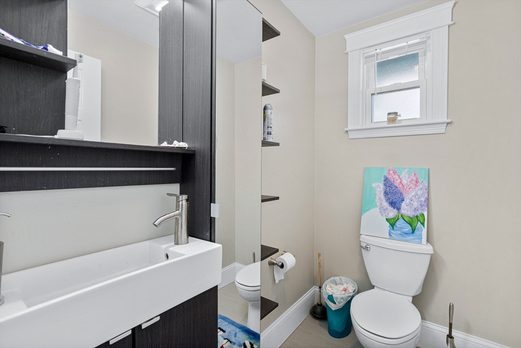 79 Saxton Street, Unit 3 Boston, MA 02125 - Photo 8 of 12 a bathroom with a sink a toilet and a mirror