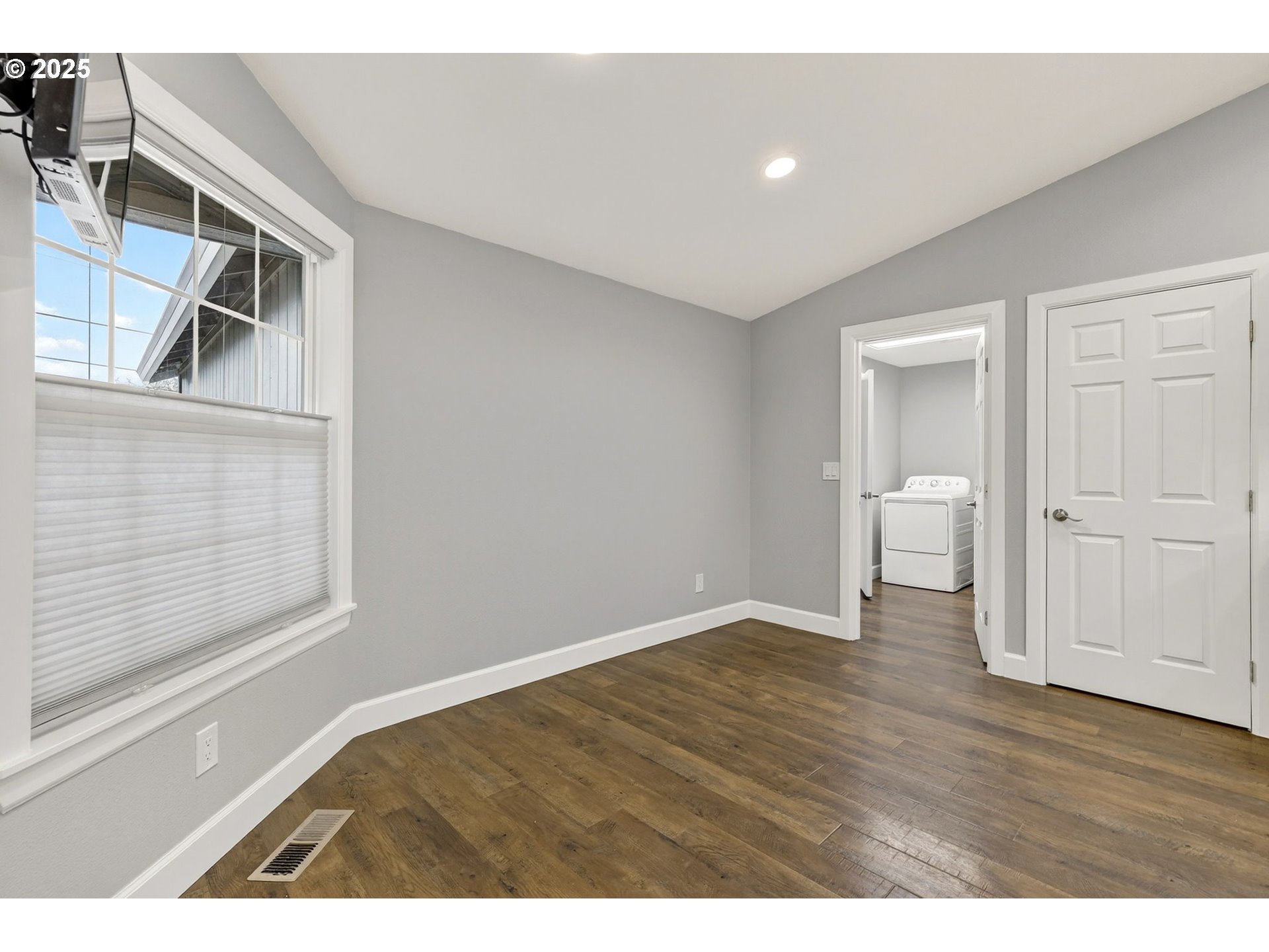 5118 Northeast Jarrett Street Portland, OR 97218 - Photo 11 of 46 a view of an empty room with wooden floor and a window
