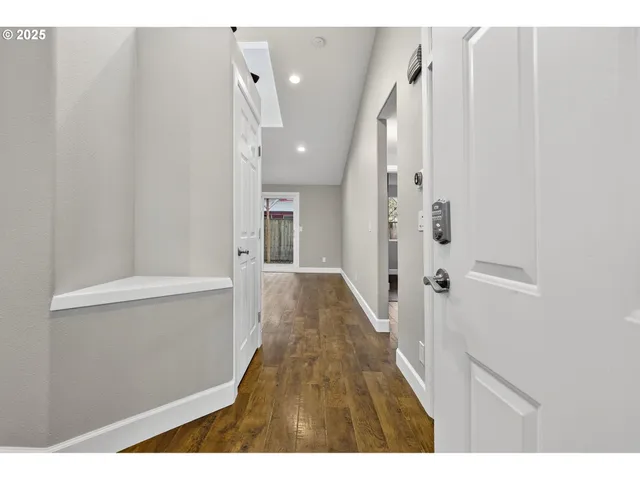 a view of hallway with wooden floor