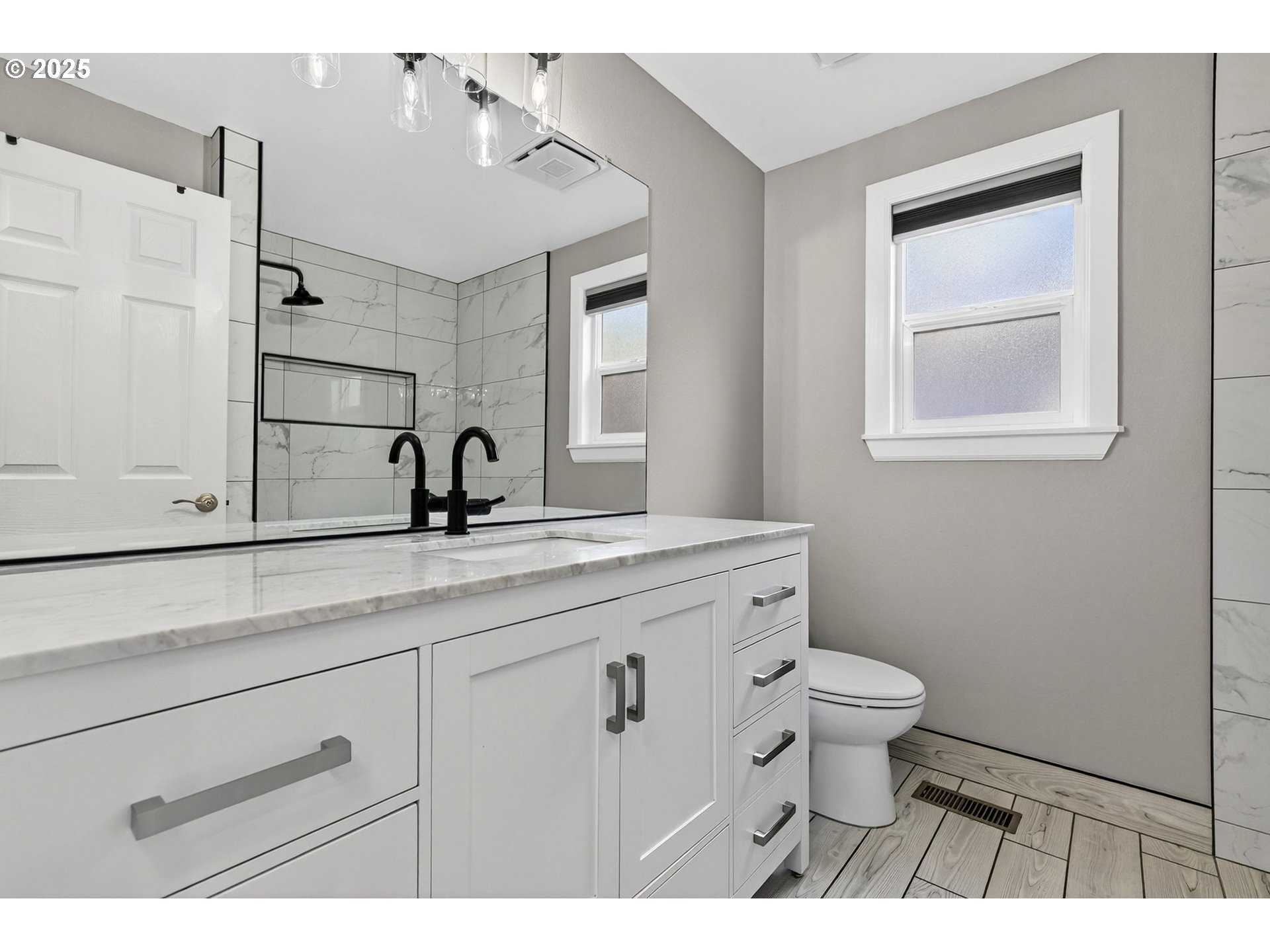 5118 Northeast Jarrett Street Portland, OR 97218 - Photo 16 of 46 a bathroom with a toilet sink and mirror