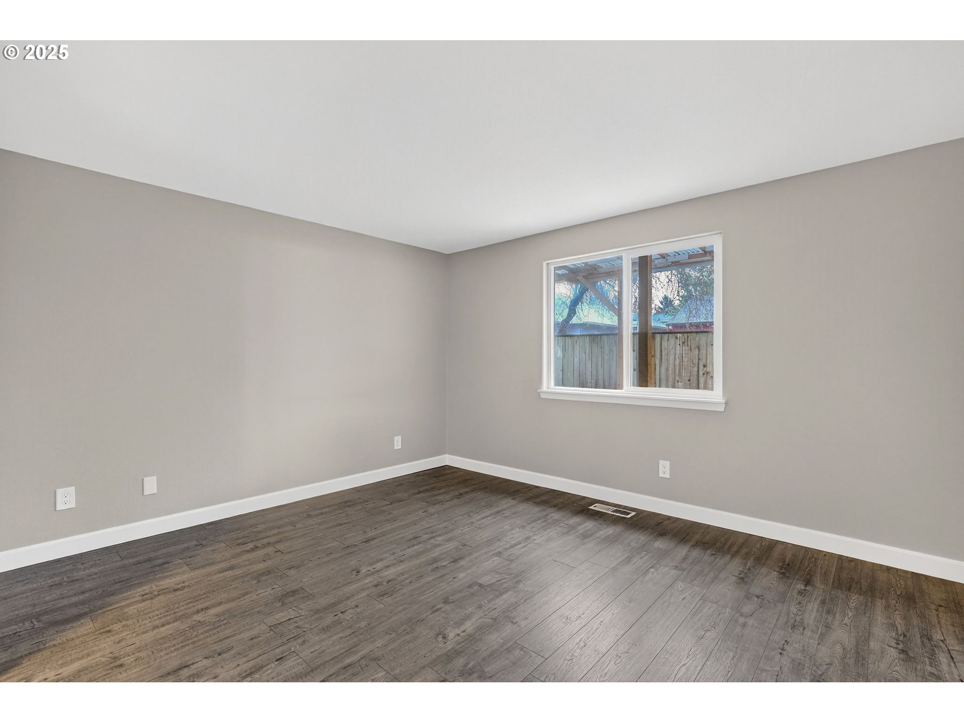 5118 Northeast Jarrett Street Portland, OR 97218 - Photo 23 of 46 an empty room with wooden floor and windows
