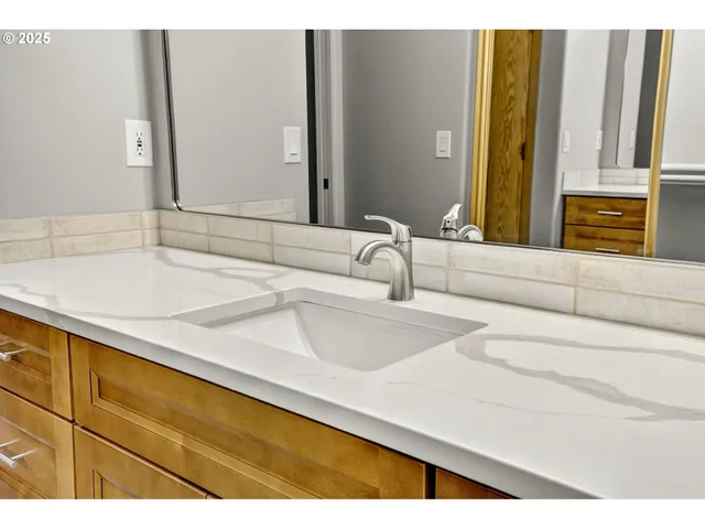 a bathroom with a toilet a sink a mirror and vanity