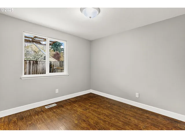 a view of an empty room with glass door
