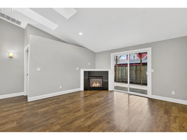 a view of a room with wooden floor and window
