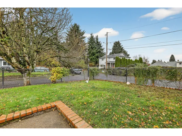 a backyard of a house with table and chairs
