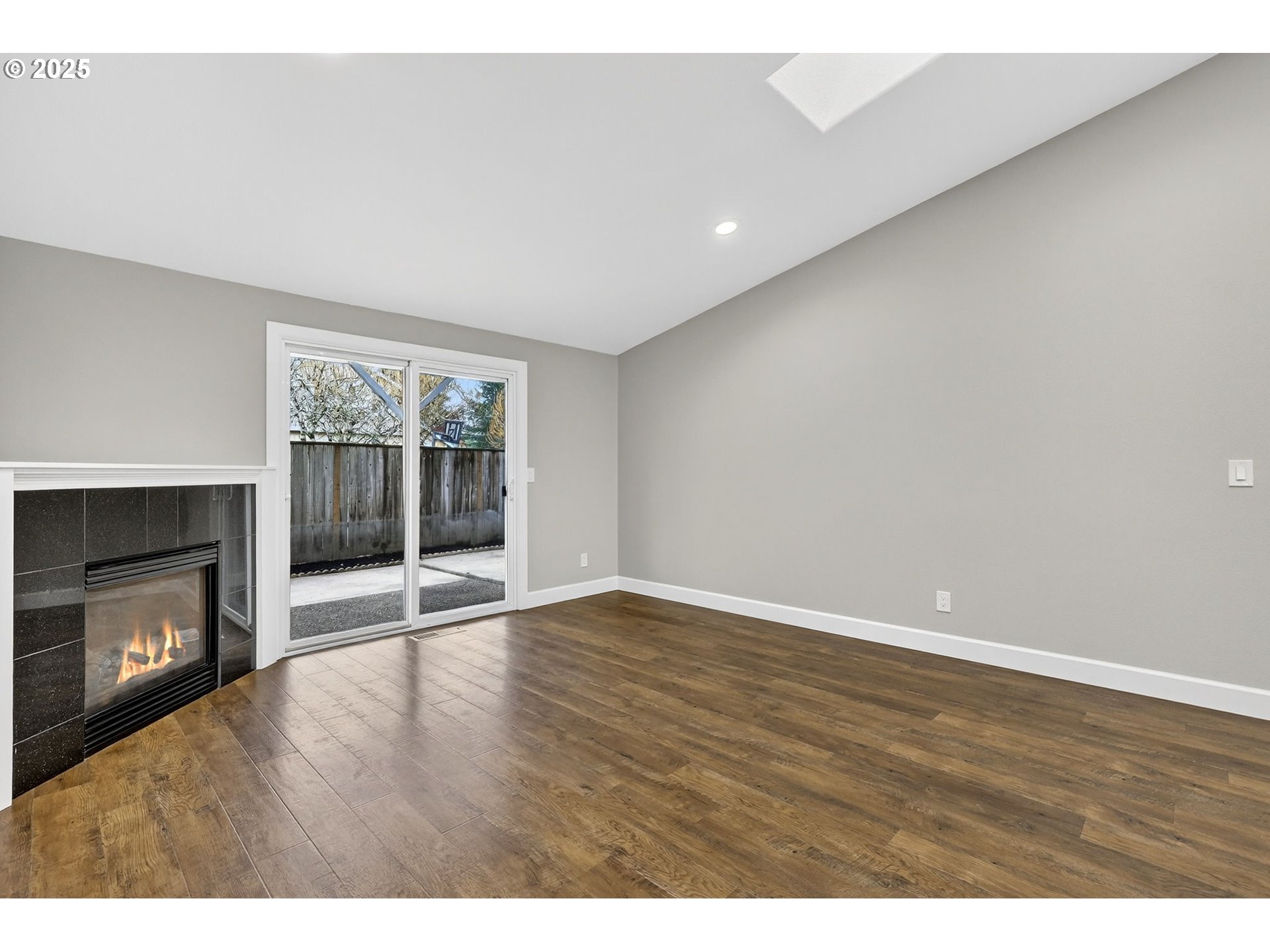 5118 Northeast Jarrett Street Portland, OR 97218 - Photo 5 of 46 a view of an empty room with a fireplace and a window