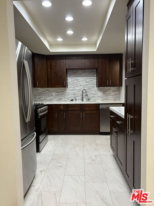 8162 Manitoba Street, Unit 111 Playa del Rey, CA 90293 - Photo 5 of 17 a large kitchen with a large counter top stainless steel appliances and cabinets