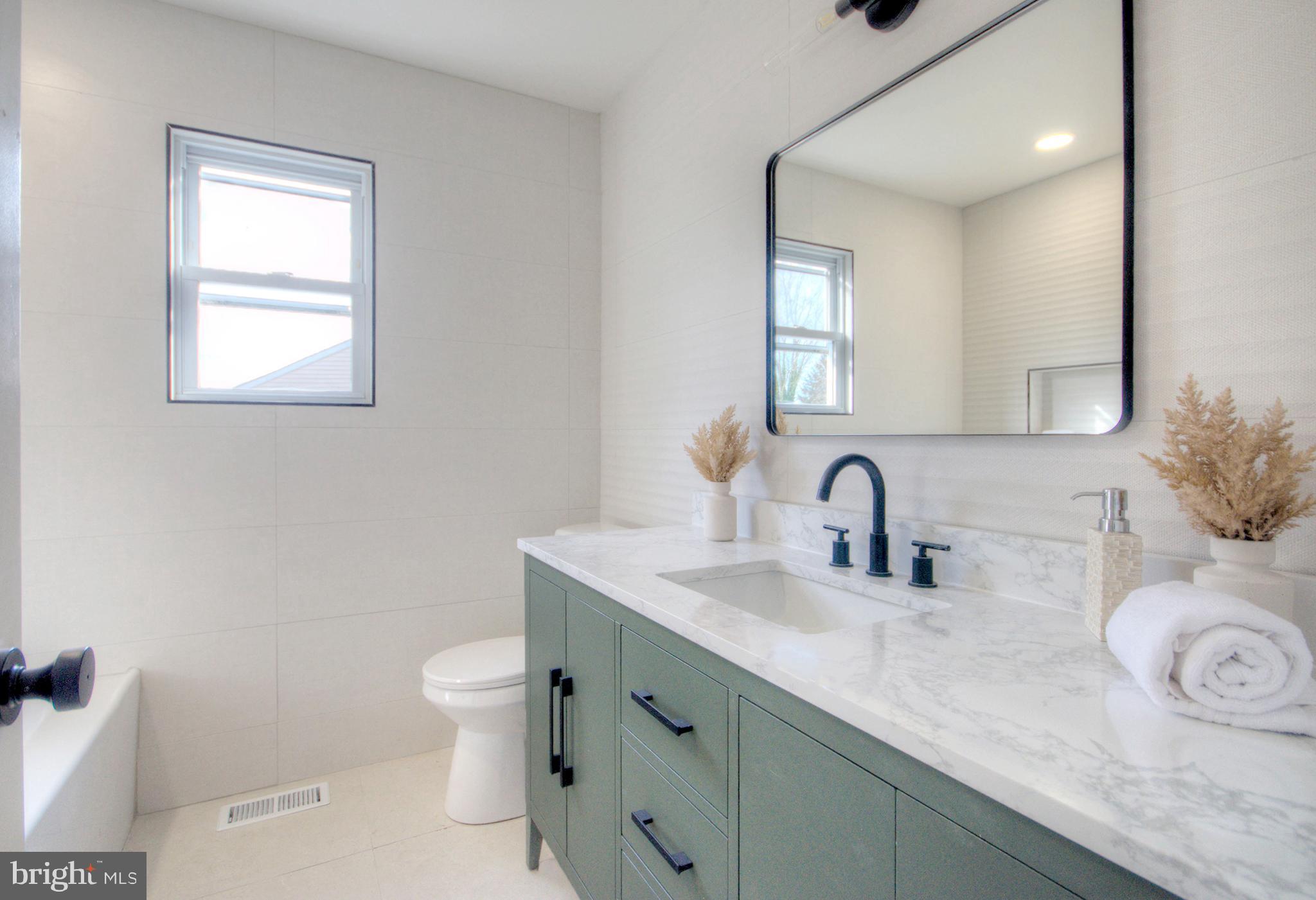 921 North Beecham Road Williamstown, NJ 08094 - Photo 37 of 43 a bathroom with a granite countertop toilet sink mirror and window