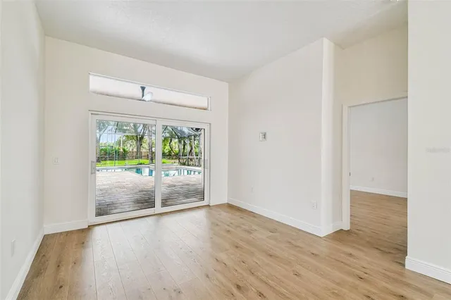 a view of an empty room with a fireplace and a window