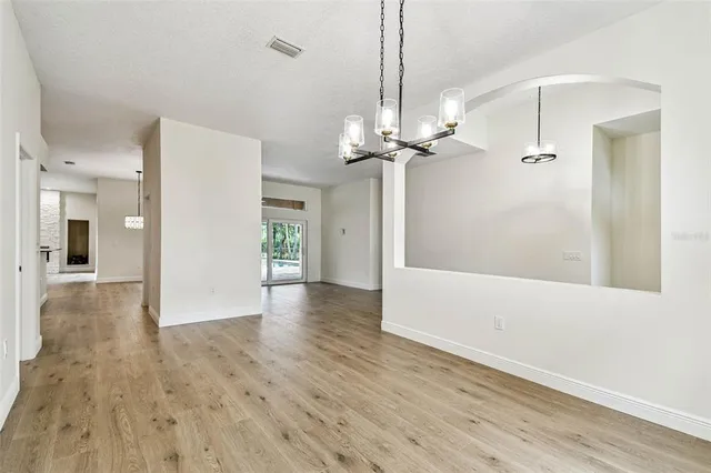 a view of room with window ceiling fan and hardwood floor