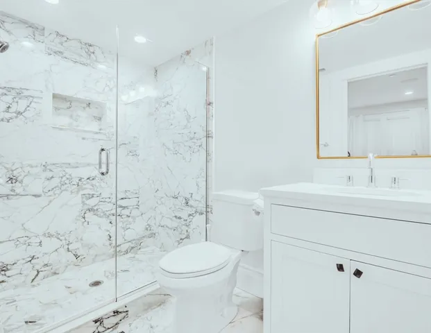 a bathroom with a sink toilet and shower