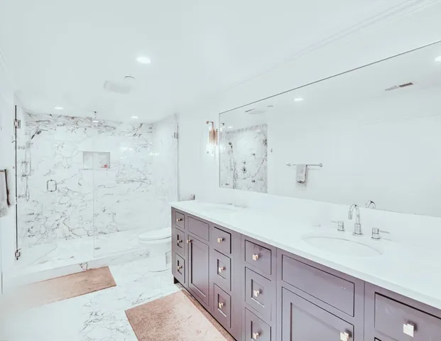 a bath room with a sink tub vanity and a shower
