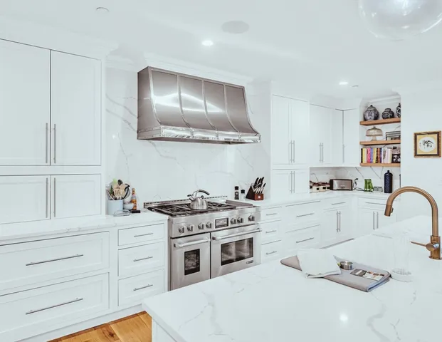 a kitchen with cabinets appliances and a sink