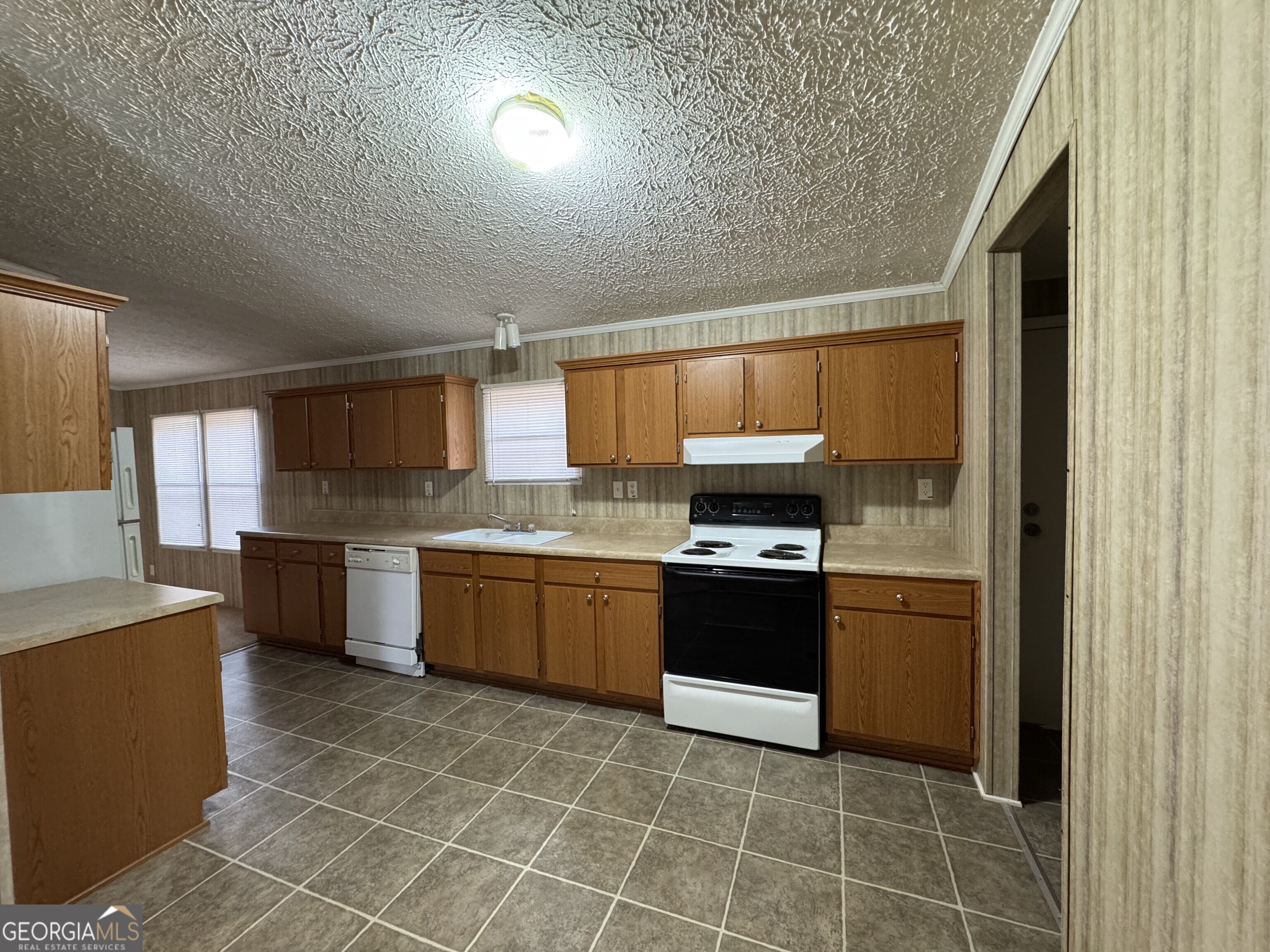 2278 Providence Church Road Lavonia, GA 30553 - Photo 11 of 16 a kitchen with stainless steel appliances granite countertop a stove a sink and a refrigerator