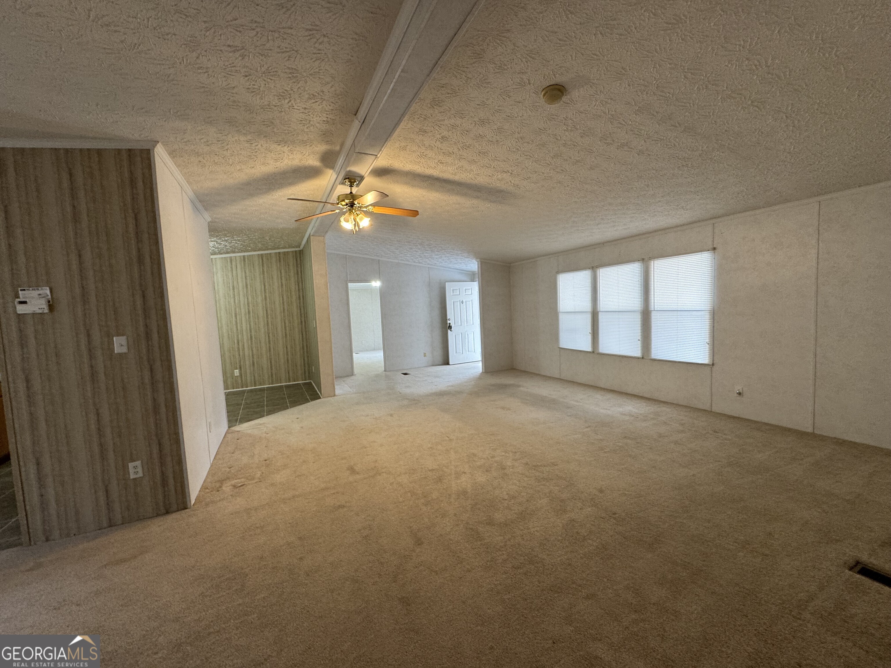 2278 Providence Church Road Lavonia, GA 30553 - Photo 7 of 16 en empty room with windows and ceiling fan