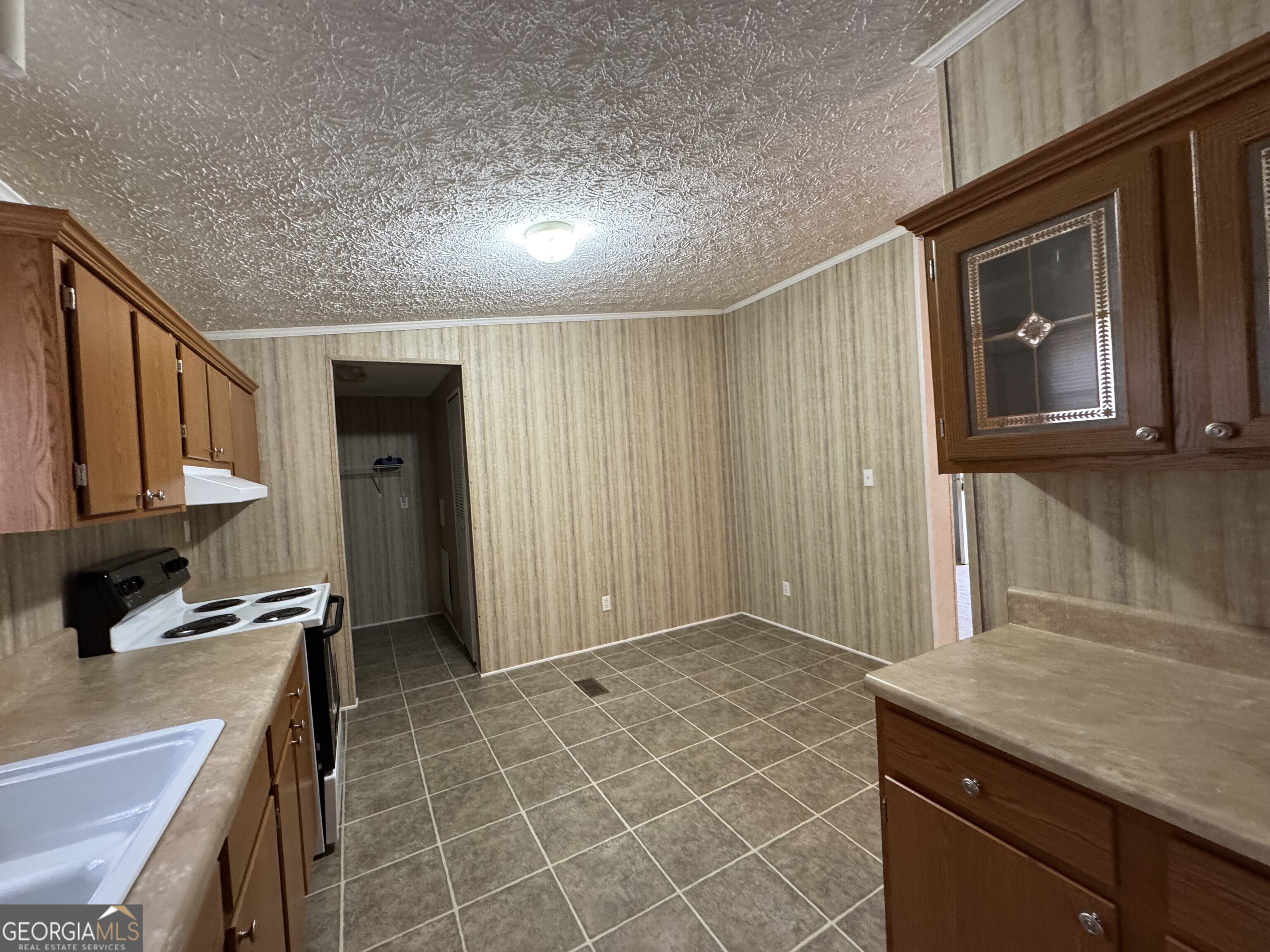 2278 Providence Church Road Lavonia, GA 30553 - Photo 10 of 16 a kitchen with kitchen island granite countertop a sink stove and cabinets