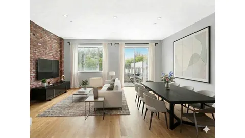 a living room with furniture a flat screen tv and a large window