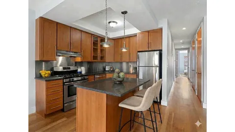 a bathroom with a double vanity sink toilet and shower