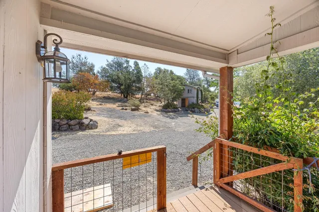 a view of a balcony with wooden fence and floor