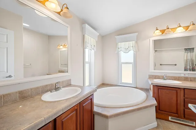 a bathroom with a sink a toilet and mirror