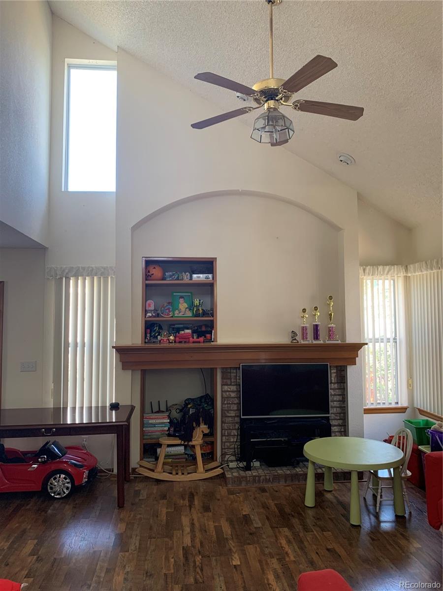 1187 West 133rd Way Westminster, CO 80234 - Photo 2 of 10 a living room with furniture and a fireplace