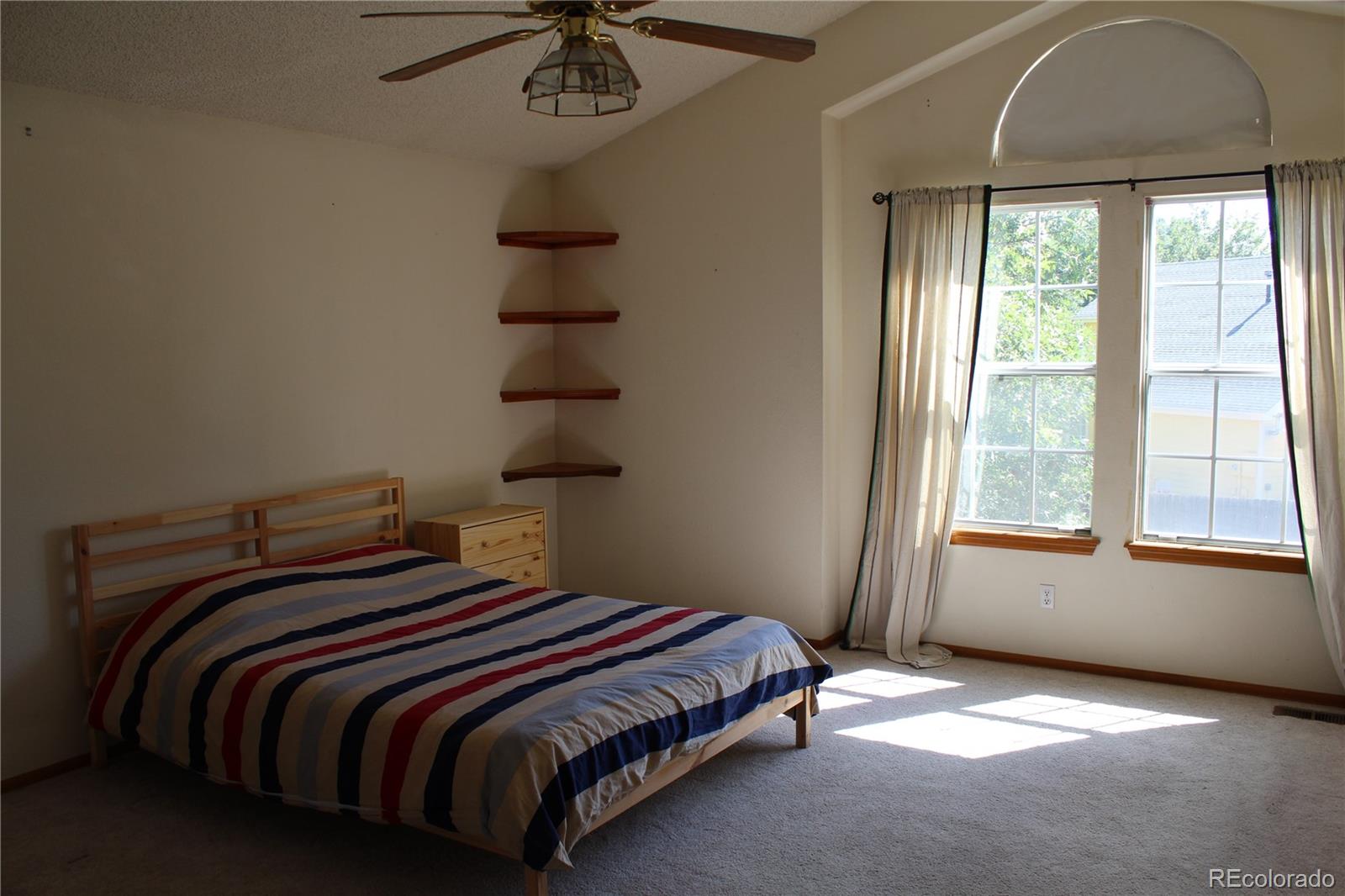 1187 West 133rd Way Westminster, CO 80234 - Photo 5 of 10 a bedroom with a bed and a window