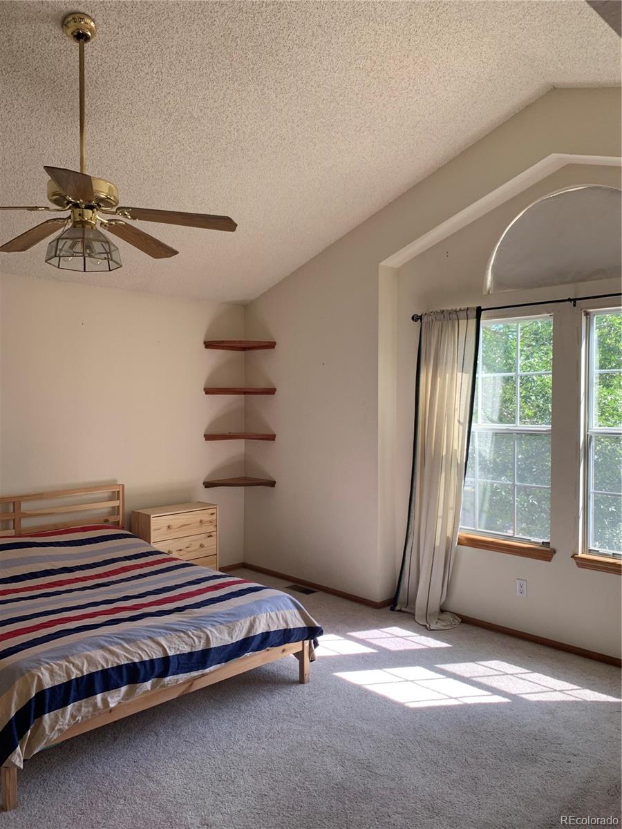 1187 West 133rd Way Westminster, CO 80234 - Photo 6 of 10 a bedroom with a bed and a window