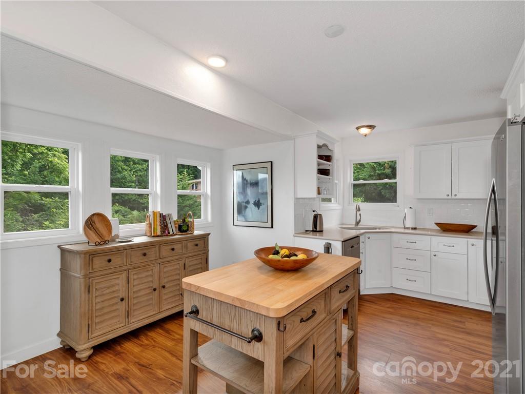 920 Hall Top Road Waynesville, NC 28786 - Photo 13 of 36 a kitchen that has a stove and a wooden floor