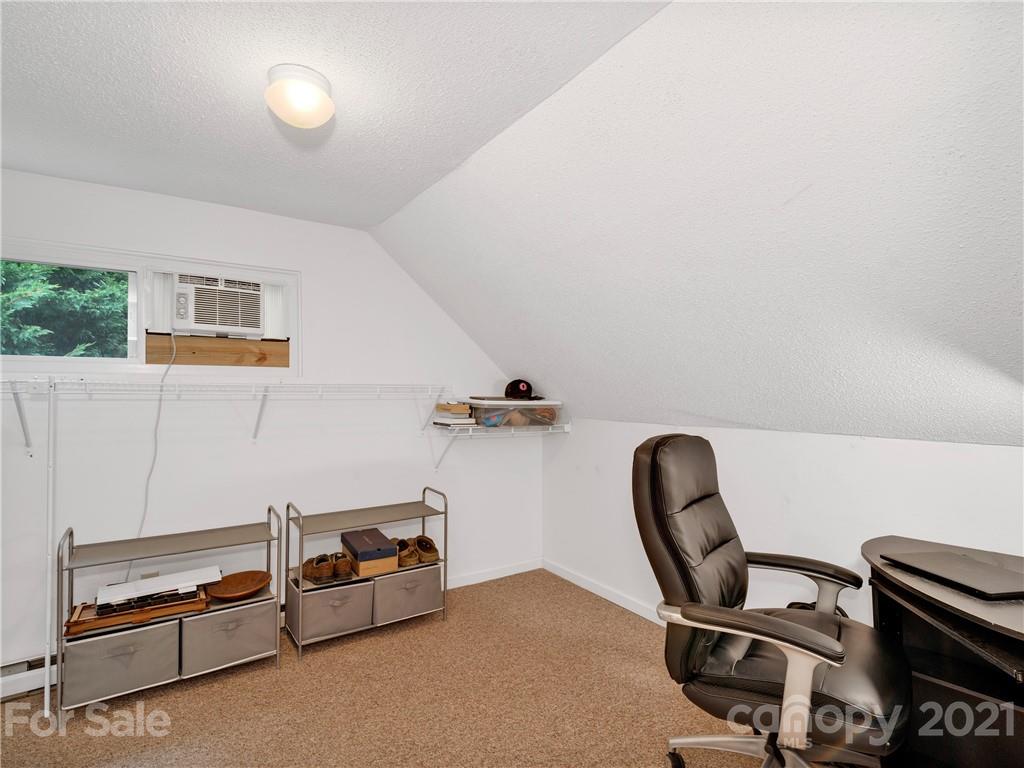 920 Hall Top Road Waynesville, NC 28786 - Photo 18 of 36 a room with a chair and white walls