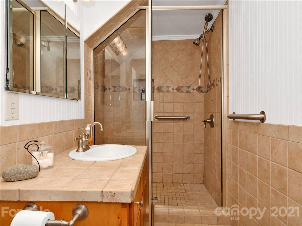 920 Hall Top Road Waynesville, NC 28786 - Photo 19 of 36 a bathroom with a sink and shower