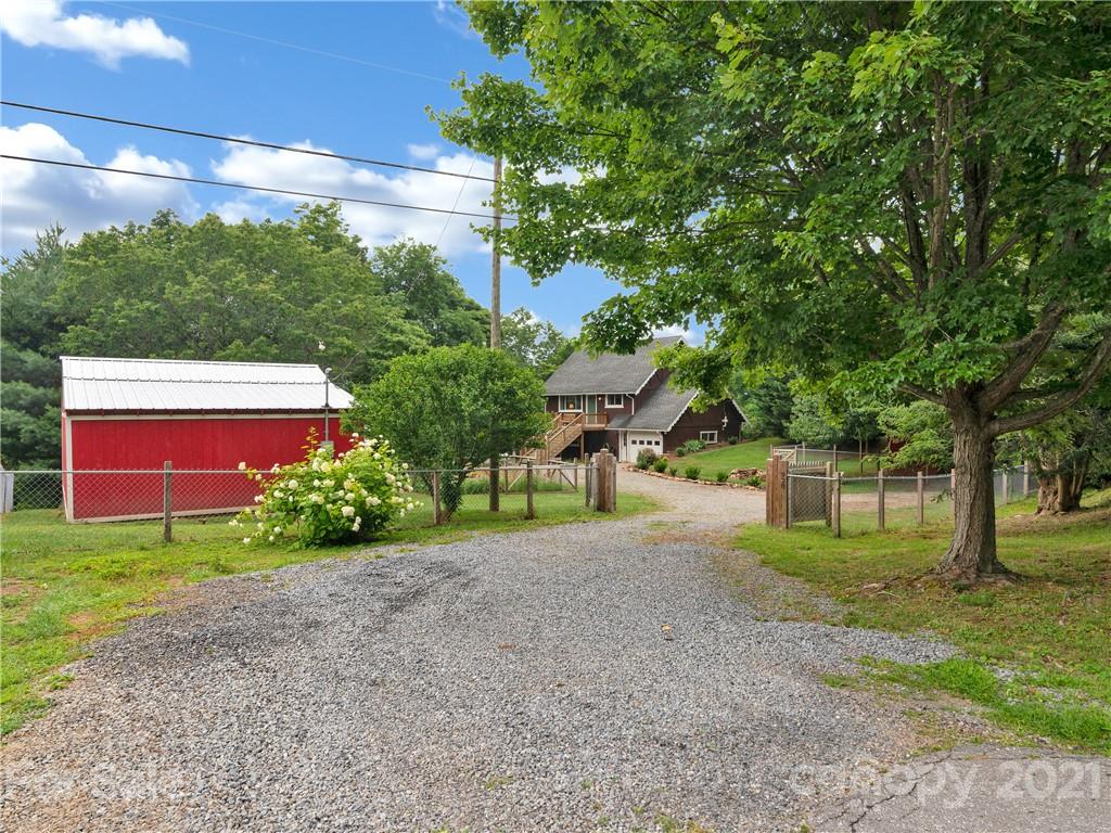 920 Hall Top Road Waynesville, NC 28786 - Photo 3 of 36 a front view of a house with garden