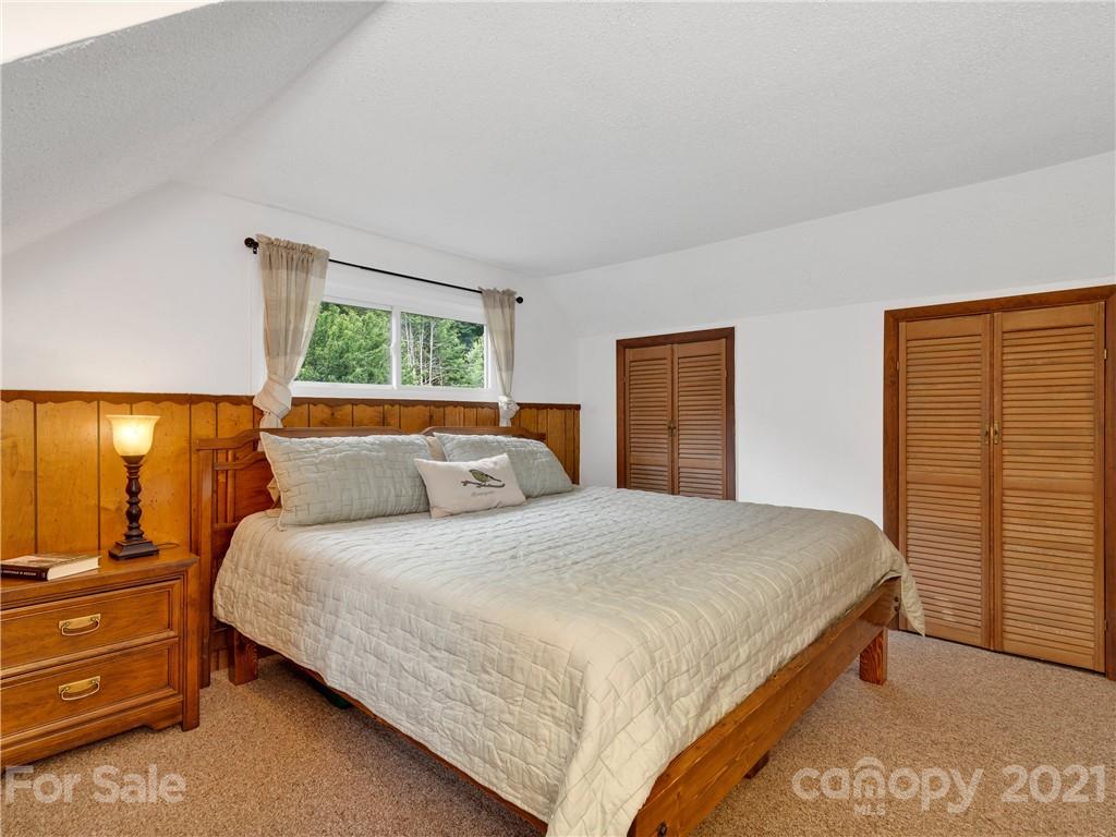 920 Hall Top Road Waynesville, NC 28786 - Photo 22 of 36 a bedroom with a bed and window