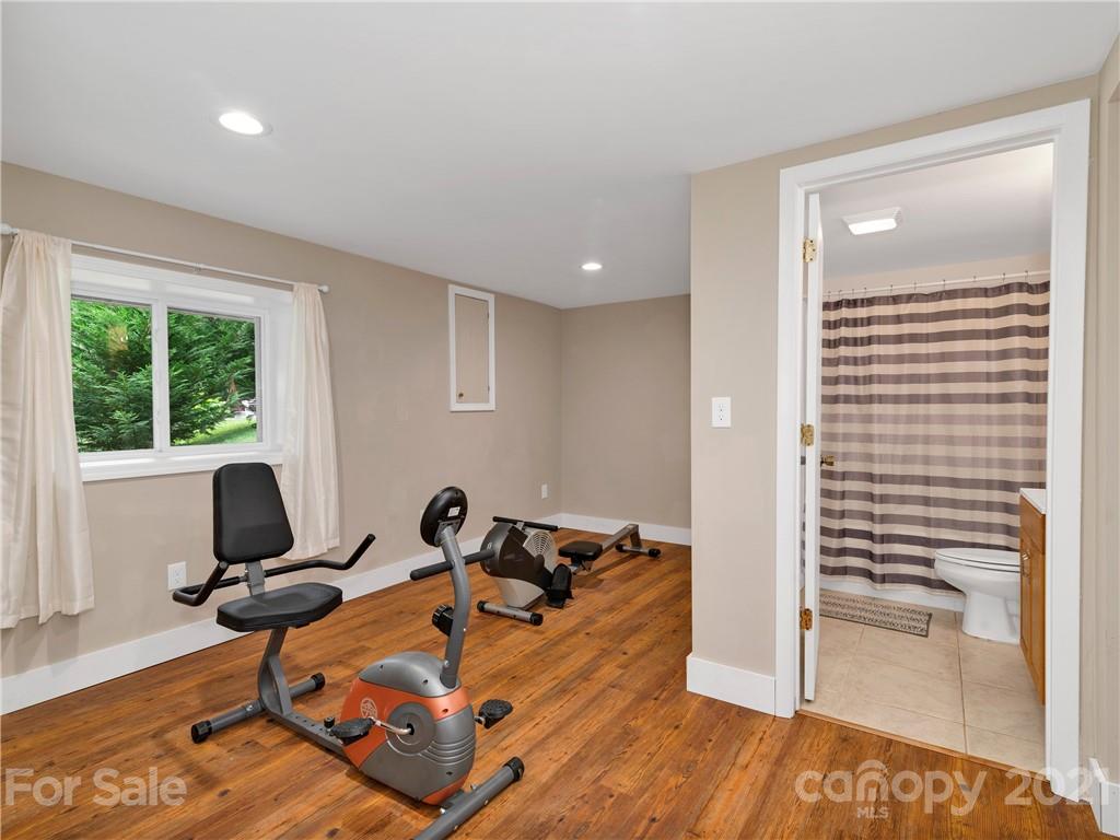 920 Hall Top Road Waynesville, NC 28786 - Photo 27 of 36 a living room with furniture hard wood floor and a floor to ceiling window