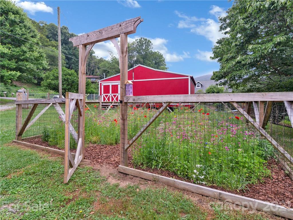920 Hall Top Road Waynesville, NC 28786 - Photo 32 of 36 a view of a yard with sitting area and garden