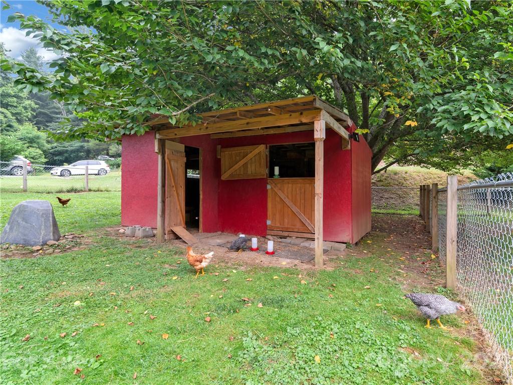 920 Hall Top Road Waynesville, NC 28786 - Photo 35 of 36 a view of backyard with wooden fence and large trees