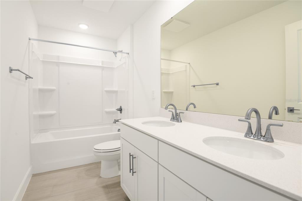 153 Waterstone Loop Tavares, FL 32778 - Photo 15 of 22 a bathroom with a sink a toilet and shower