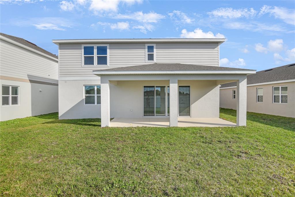 153 Waterstone Loop Tavares, FL 32778 - Photo 21 of 22 a front view of a house with a yard and garage