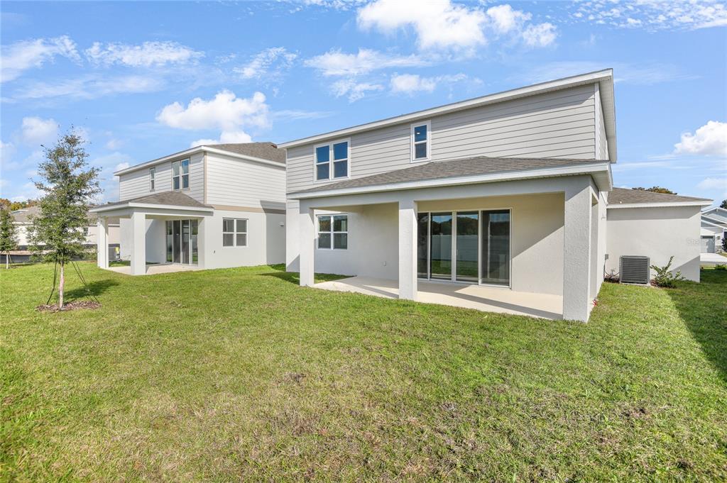 153 Waterstone Loop Tavares, FL 32778 - Photo 22 of 22 a front view of a house with garden