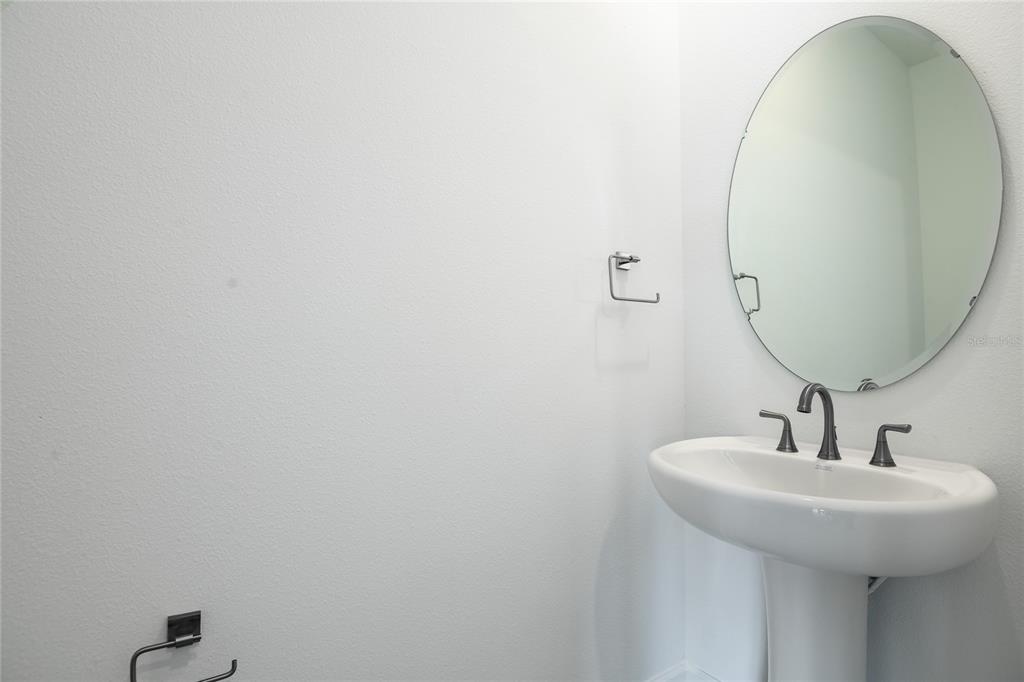 153 Waterstone Loop Tavares, FL 32778 - Photo 5 of 22 a bathroom with a sink and mirror