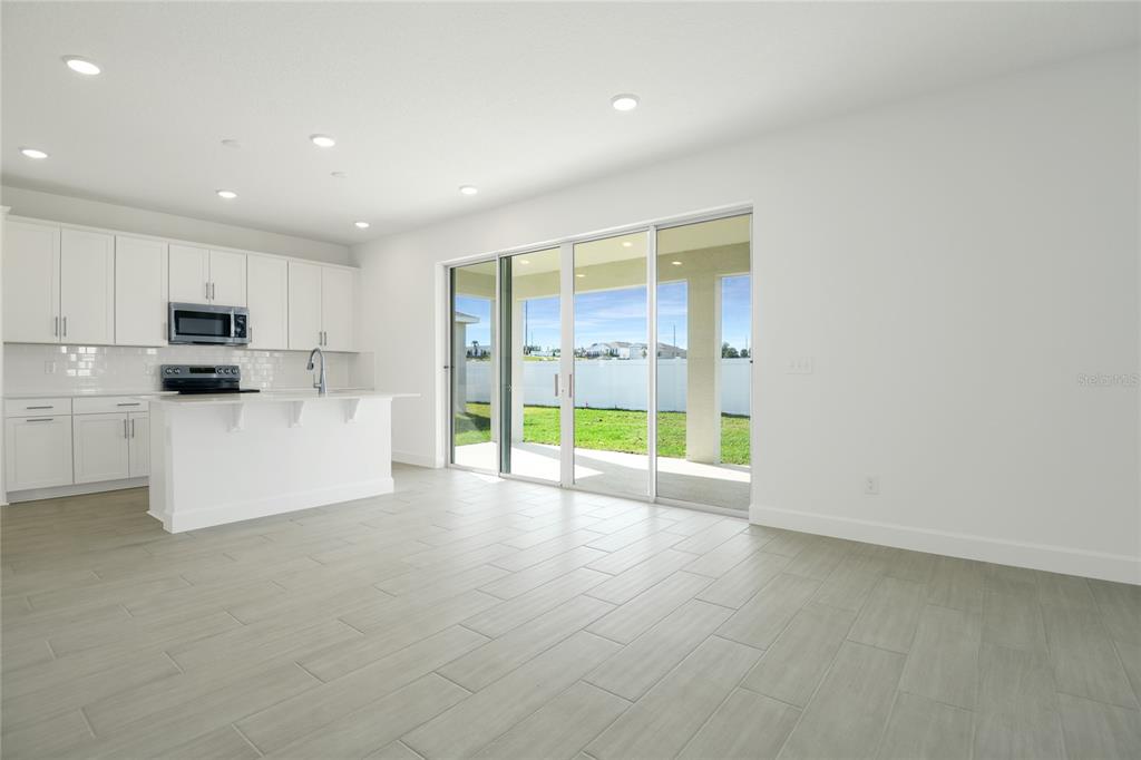 153 Waterstone Loop Tavares, FL 32778 - Photo 10 of 22 a view of an empty room with a kitchen
