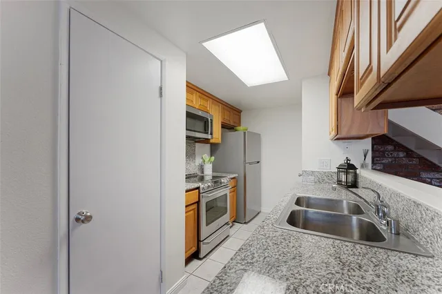 a view of kitchen with granite countertop cabinets and wooden floor