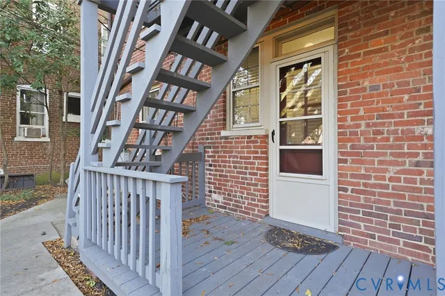 a view of front door of house with stairs