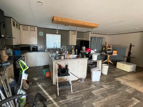 a living room with furniture a flat screen tv and a table