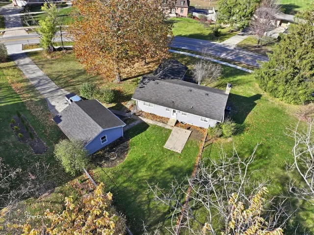 an aerial view of a house with a yard
