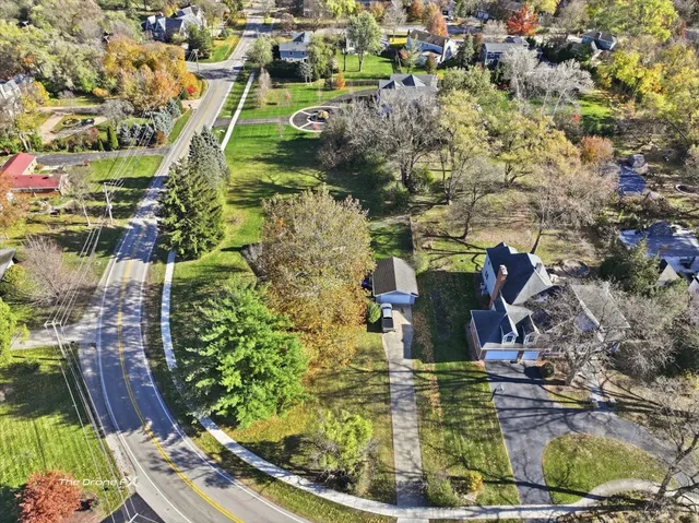 an aerial view of a house with a yard