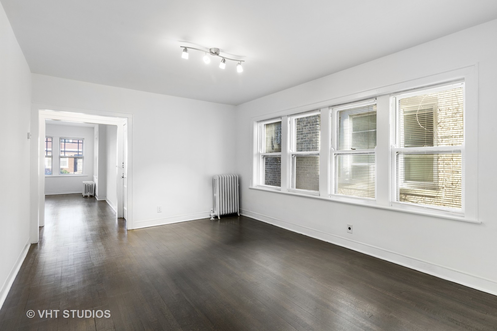 8030 South Justine Street Chicago, IL 60620 - Photo 12 of 12 an empty room with wooden floor and windows