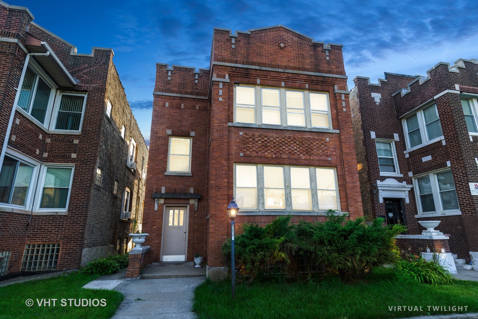 8030 South Justine Street Chicago, IL 60620 - Photo 2 of 12 a front view of a residential apartment building with a yard