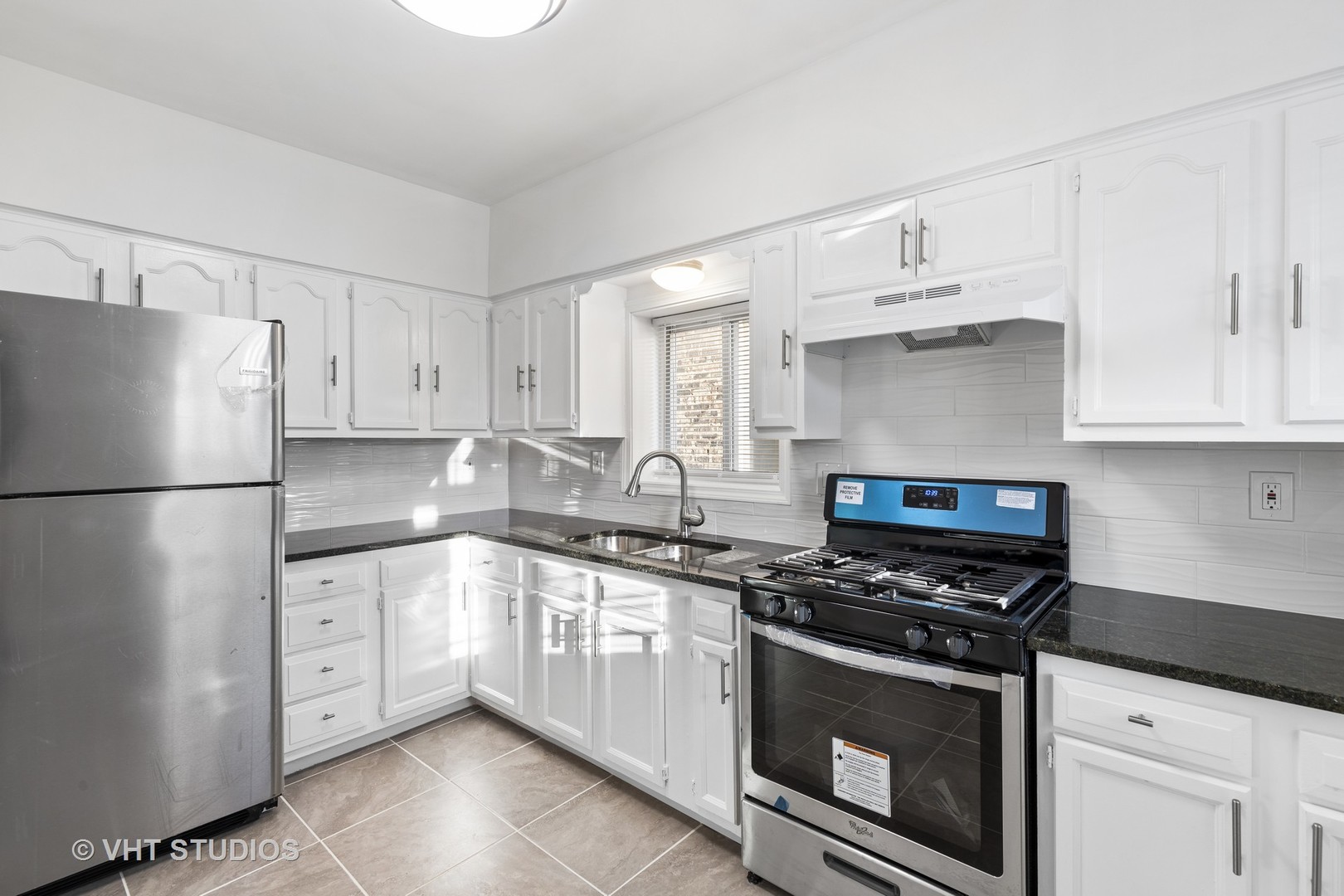 8030 South Justine Street Chicago, IL 60620 - Photo 5 of 12 a kitchen with white cabinets and white appliances