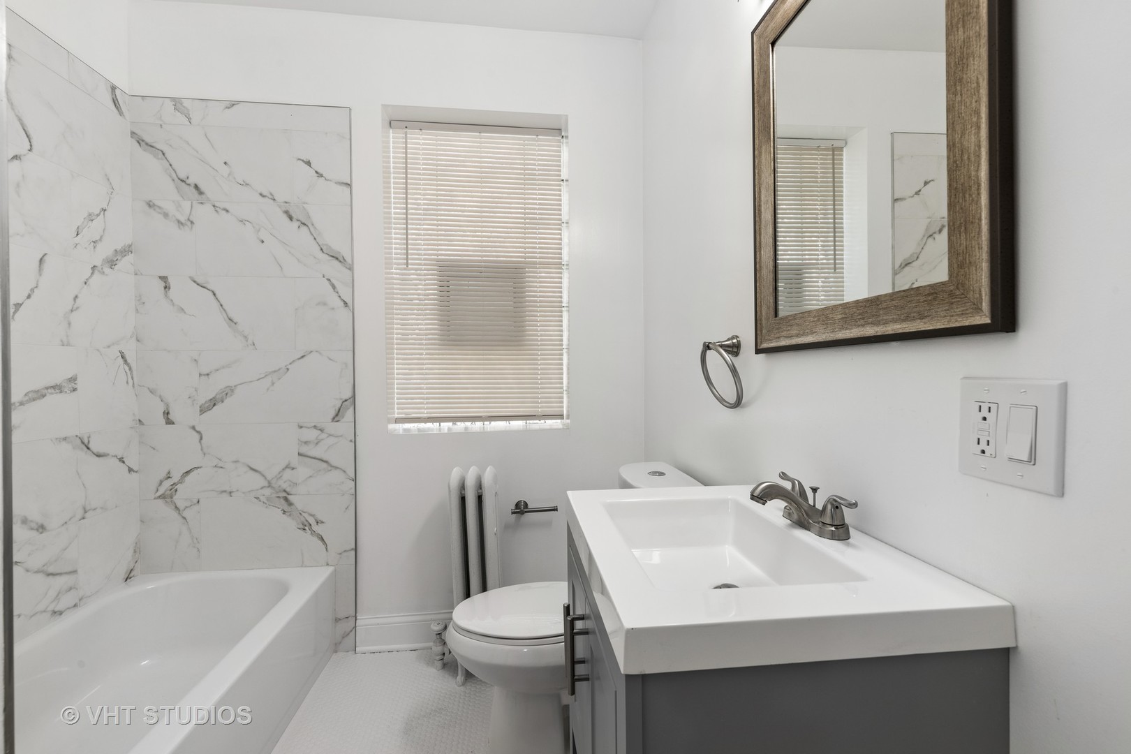 8030 South Justine Street Chicago, IL 60620 - Photo 9 of 12 a bathroom with a sink a toilet and shower